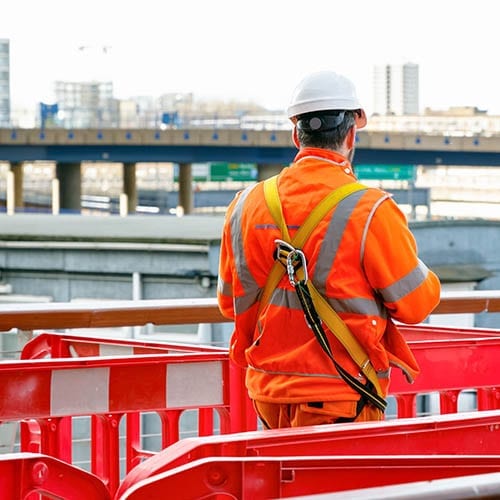 Back view of a construction worker walking into a building site - cis tax advice image