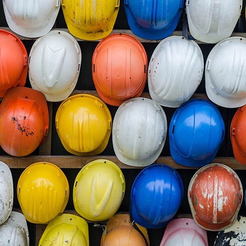 Colourful helmets on a wall