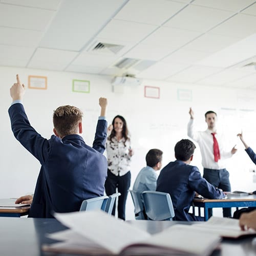 Conversion support image - students raising their hands in class