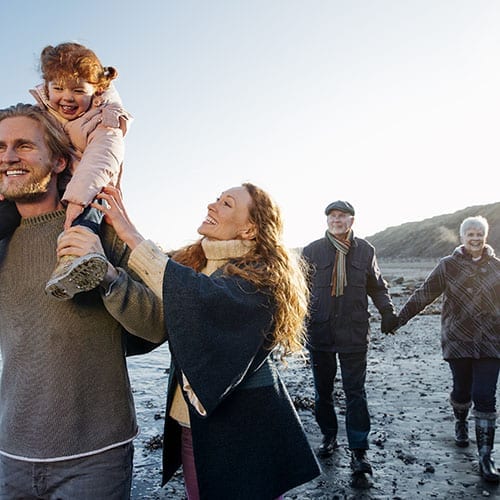 Family walking down the beach - Trusts and Estates page