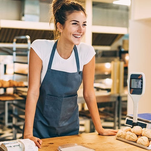 Food and drink image - small business owner serving in her bakery