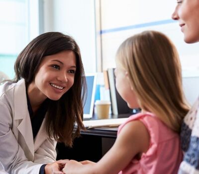 GP Consultant With A Child Patient