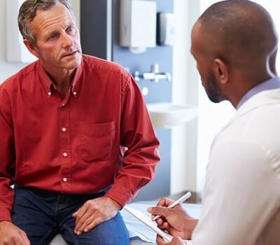 GP Consultation - Doctor Talking To His Patient