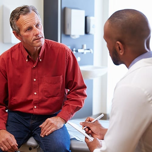 GP consultation - doctor talking to his patient