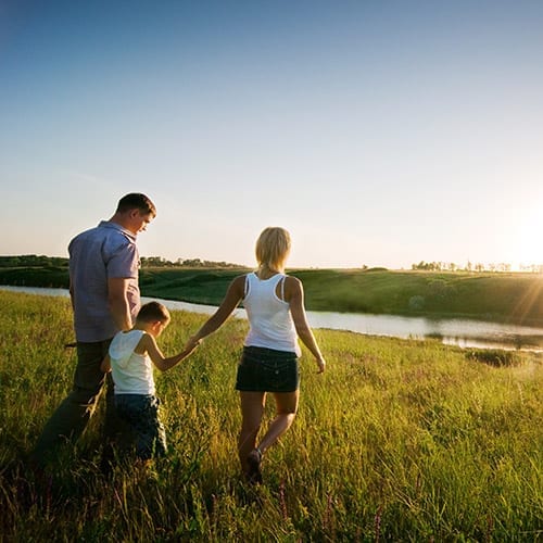 family enjoying a walk in beautiful fields