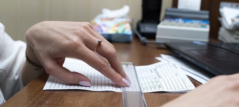 Woman using ruler on paper form document