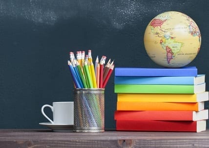 World globe on books on school teacher's desk
