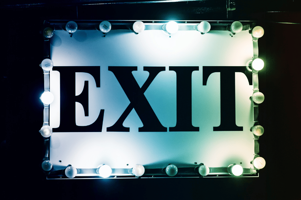 exit sign surrounded by bright lights