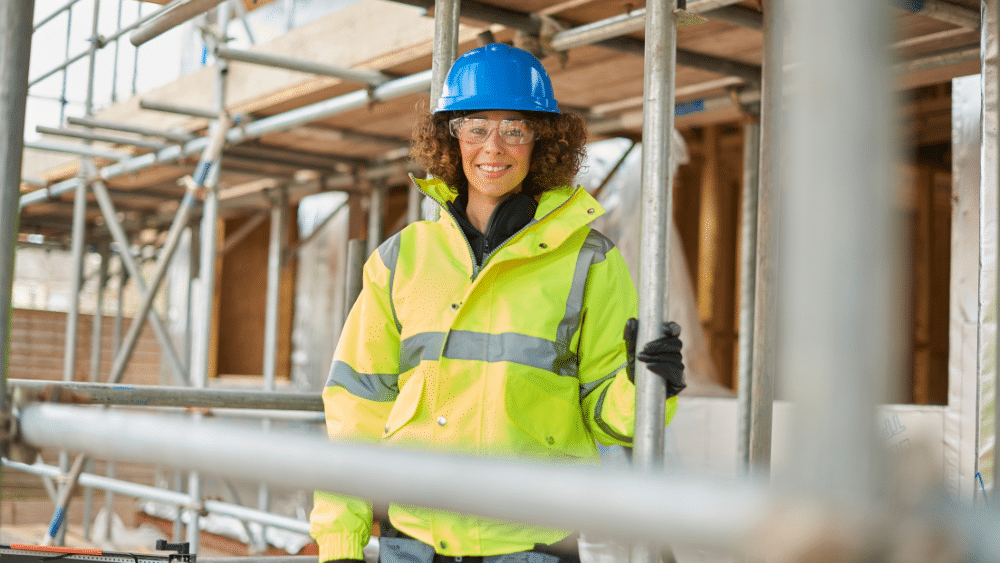 Female building contractor standing on scaffolding
